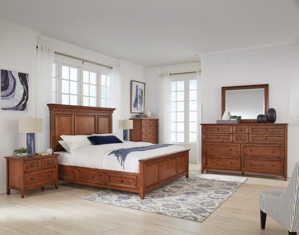 McKenzie 3-Drawer Wide Nightstand in glazed antique cherry finish shown in bedroom set